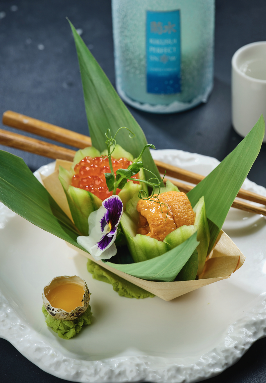 Uni and salmon roe in cucumber cups, garnished with an edible flower